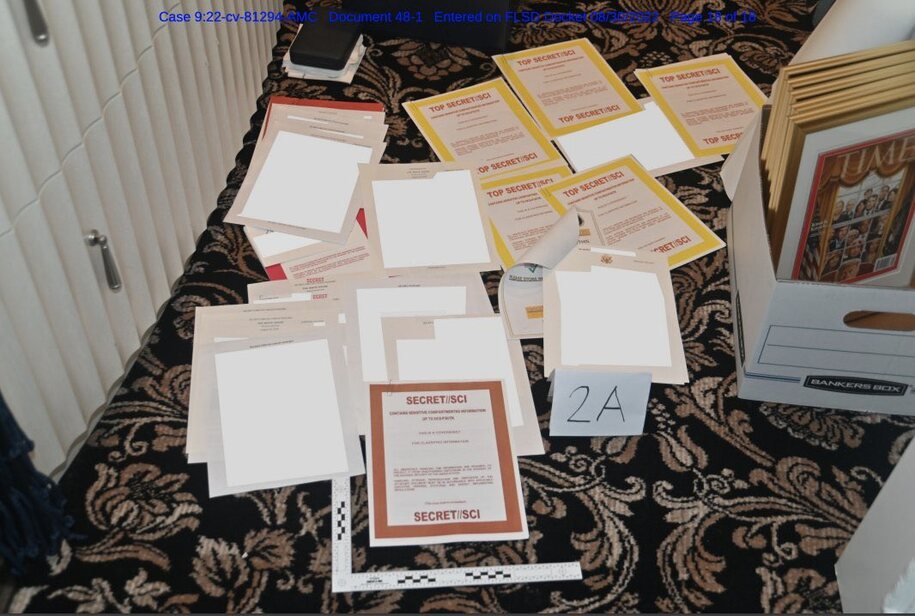 Image from DOJ response showing classified documents on the floor of Trump's office in Mar-a-Lago